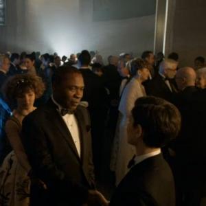 Screen shot from Under the Knife Episode 20 Season 1 of Gotham Here at the Wayne Charity Ball as a guest seen in the upper right corner immediately to the right of the guest wearing the silver gown