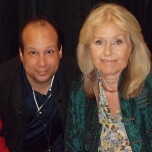Michael J Tomaso and British actress Suzanna Leigh The Deadly Bees 1966 The Lost Continent 1968 and Lust for a Vampire 1971 pose for a photo at Spooky Empire in Orlando FL in October 2014