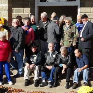 A candid group shot taken of many of the cast members from George Romero's original 'living dead' trilogy; immediately following the Evans City Cemetery Chapel Re-Dedication Ceremony on October 11, 2014.