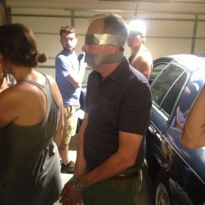 From the set of Killer Couples (Episode 206) Patrick Higgs (duct taped) as Reggie Sumner, the victim in the episode.