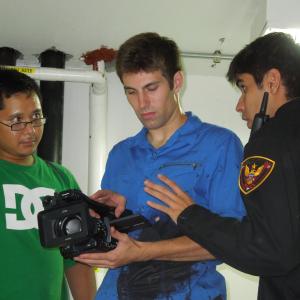 Jarrod Crooks on set of Dispatched checking a shot with Randy Vongphakdy and Jose Manuel