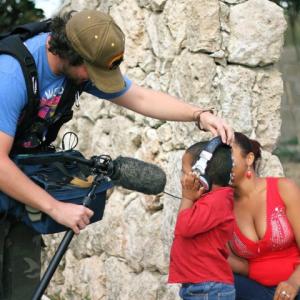 Showing the local children how to record sound while filming in the Dominican Republic