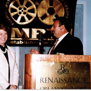 Cummings presents award as State President of FL Motion Picture and Television Assoc