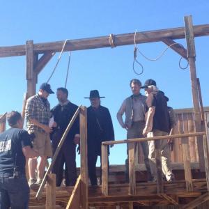 WriterDirector Thomas Torrey with actors Pat Dortch Edward James Olmos and Isaiah Stratton and cinematographer Renyaldo Villalobos on the set of House of the Righteous 2014