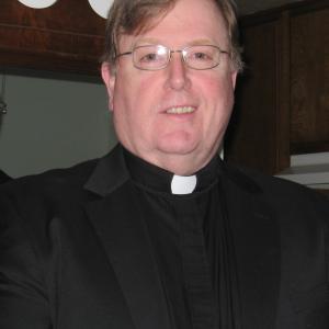 Thomas F. Evans as Fr. Ron.