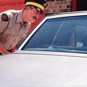 Production photo from the Convicted by a Hair episode of Animal Witness in role of RCMP officer