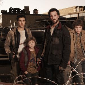 Promotional still from the TNT series Falling Skies From left to right Drew Roy as Hal Maxim Knight as Matt Noah Wyle as Tom and Connor Jessup as Ben