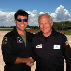Matthew F Reyes greets astronaut Buzz Aldrin after flying aboard the ZEROG aircraft