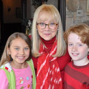 Caitlin Carmichael Shelley Long and Wyatt Griswold on set of The Dog Who Saved Christmas Eve 2012