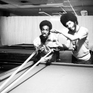 Cinematographer Adrian Best takes a shot at the pool table with assistant cameraman Ronald Gray during the filming of POOL HALL GIRL
