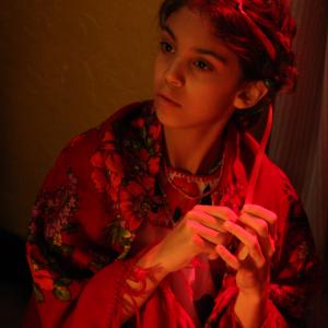 Anne Marie playing the role of a mournful, indigneous Mexican girl, 