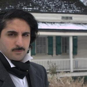 Actor Tristan Laurence playing Edgar Allan Poe in the Fools of El Dorado photo taken  The Poe Cottage Bronx NY
