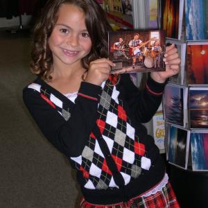 Jacquelyn holding a Greeting card by Avanti that she modeled for..She is girl jumping with braids in front..