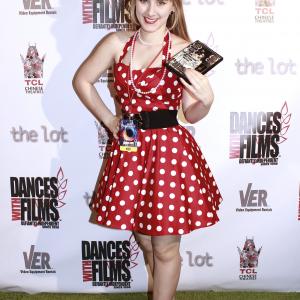 Tara-Nicole Azarian poses on the green carpet with her film 