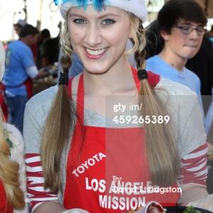 Tara-Nicole Azarian helps serve Christmas dinner to the homeless at the LA Mission 2013