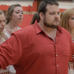 A still from Monsters on Main Street featuring Brad Leo Lyon as Coach Paul Blake.
