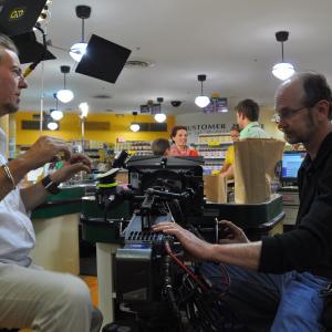 Director Doug Jefferson discusses the shot with AC Steve Cates on location in a grocery store