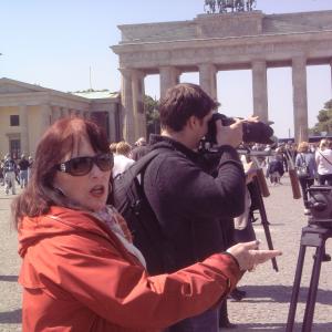 Joanna M Champlin directs a handheld shot in Berlin