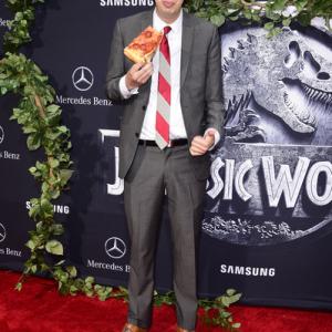 Matty Cardarople enjoying a slice of pizza on the red carpet of the world premiere of Jurassic World.