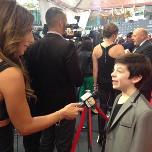 Peter DaCunha being interviewed by ET Canada at Toronto International Film Festival's red carpet for 