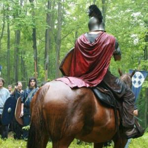 Aaron Burns on horseback, filming Pendragon: Sword of his Father