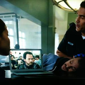 Sill from Xfinity Streampix commercial in which a criminal portrayed by Karl Maschek is mesmerized by Streaming video at the Police Station