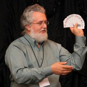 Mark Connelly Wilson performs a card trick during a lecture.