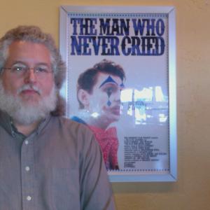 Mark Connelly Wilson standing next to the poster for the award winning short film The Man Who Never Cried for which he provided additional music and also scored the trailer