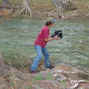 Rodger Marion shooting a handheld shot at the Blanco River