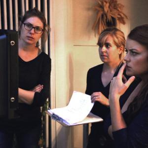 Director Sarah Phillips watches the monitor with producer Laetitia Leon