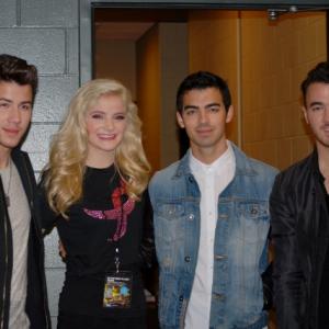 Michelle Bergh with copresentrs The Jonas Brothers at We Day MN