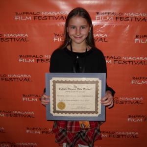 LANA ESSLINGER displaying the Buffalo/Niagara Film Festival's Youth Performance Award presented to her, for her portrayal of Grace Bedell.