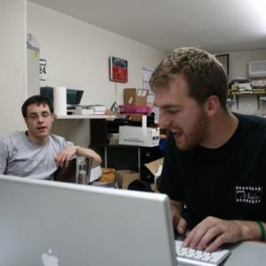 Michael Wickham (right) with his friend and writing partner, Stephen Hensel, working late into the night on a Team Midas script.