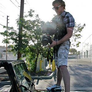 Director Hunter Davis prepping for action sequence with stunt coordinator on closed road set in East Los Angeles