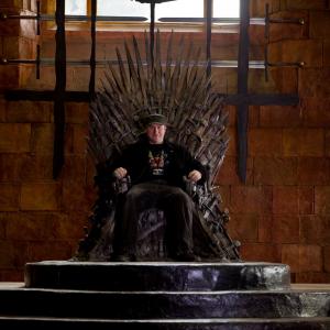 Jack Bennett seated on The Iron Throne on the set of HBO's GAME OF THRONES.