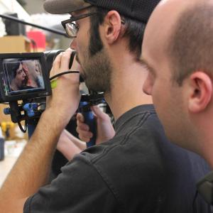 Jack Bennett directing Blood and Guts over the shoulder of cameraman Dan Kavanaugh with Scott Ian and Vanessa Cate onscreen
