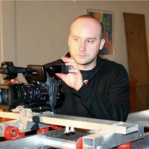 Director Jack Bennett working Charlie Wood's custom-made dolly on the set of CAPRICE (2010)