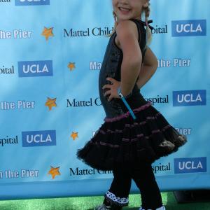 Natalia wearing Ooh! LaLa! Couture and Bon Bon Cupcake Leggings on the carpet at the 2011 Mattel Party on the Pier!