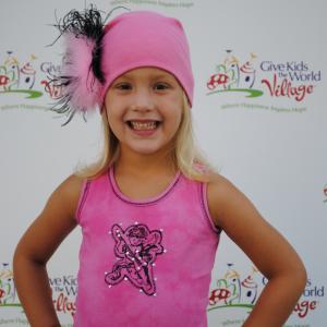 Natalia on the red carpet wearing Ooh! La,La! Couture and a Jamie Rae Hat at the Ice Cream for Breakfast Give Kids the World Village event.