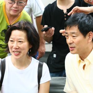 Ruby Yang on location in Shanghai with actor AIDS ambassador Pu Cunxin
