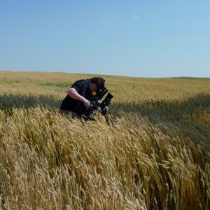 Sergio Olivares shooting in Canadian wheat field.