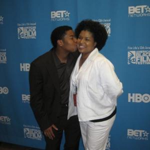 Kiel Adrian Scott kissing mother, Cara Harrison, after winning the HBO Short Film Competition.