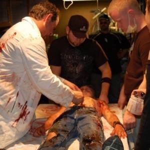 Bill Stoneking (Dr. Michael Frank) and Wesley Klepak (Bobby) go through the action with Director Mac Eldridge and special effects artists Eric Berson and Samantha Daley on the set of Chemical 12-D.