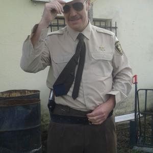 still Backseat Fighters Frank Feys as Sheriff Bakowski