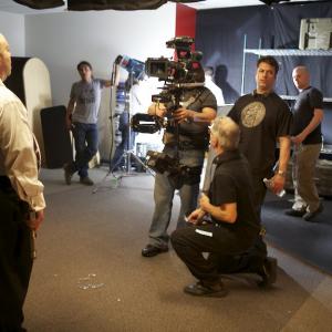 Director Paul Baker lines up a shot on actor David H. Lawrence XVII on the set of web series 
