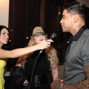 Jorie Burgos interviewing salsa singer Rik Indio and manager Marcela Olivar .