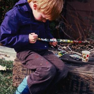 A young artist painting monsters in oil, a totem. Heath Tait.
