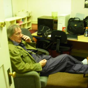 Ken Ludden on phone during break on set of AA Scene