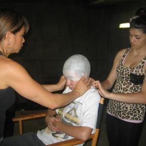 Brenden Miranda in makeup getting a skull cap on his way to transforming into the alien 