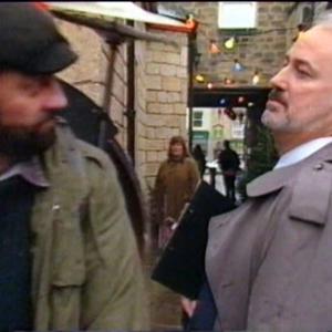 1997 YTV. Emmerdale. Council Official Dimitri Kissoff moves on busker 'Zak Dingle' (Steve Halliwell)